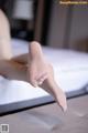 A close up of a person's feet on a bed.