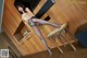 A woman in black stockings and high heels posing in a kitchen.