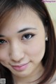 A close up of a woman's face with long brown hair.