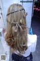 A little girl with long blonde hair in a half up half down hairstyle.