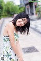 A woman in a white dress posing for a picture.