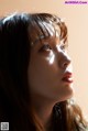 A woman with long brown hair looking up at the sky.