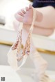 A close up of a baby's feet with a pair of ballet shoes.