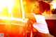 A woman leaning on the back of a red truck.