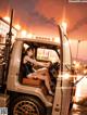 A woman sitting in the driver's seat of a truck.